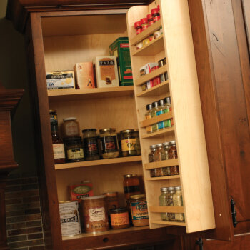A traditional cabinet door spice rack by Dura Supreme Cabinetry.